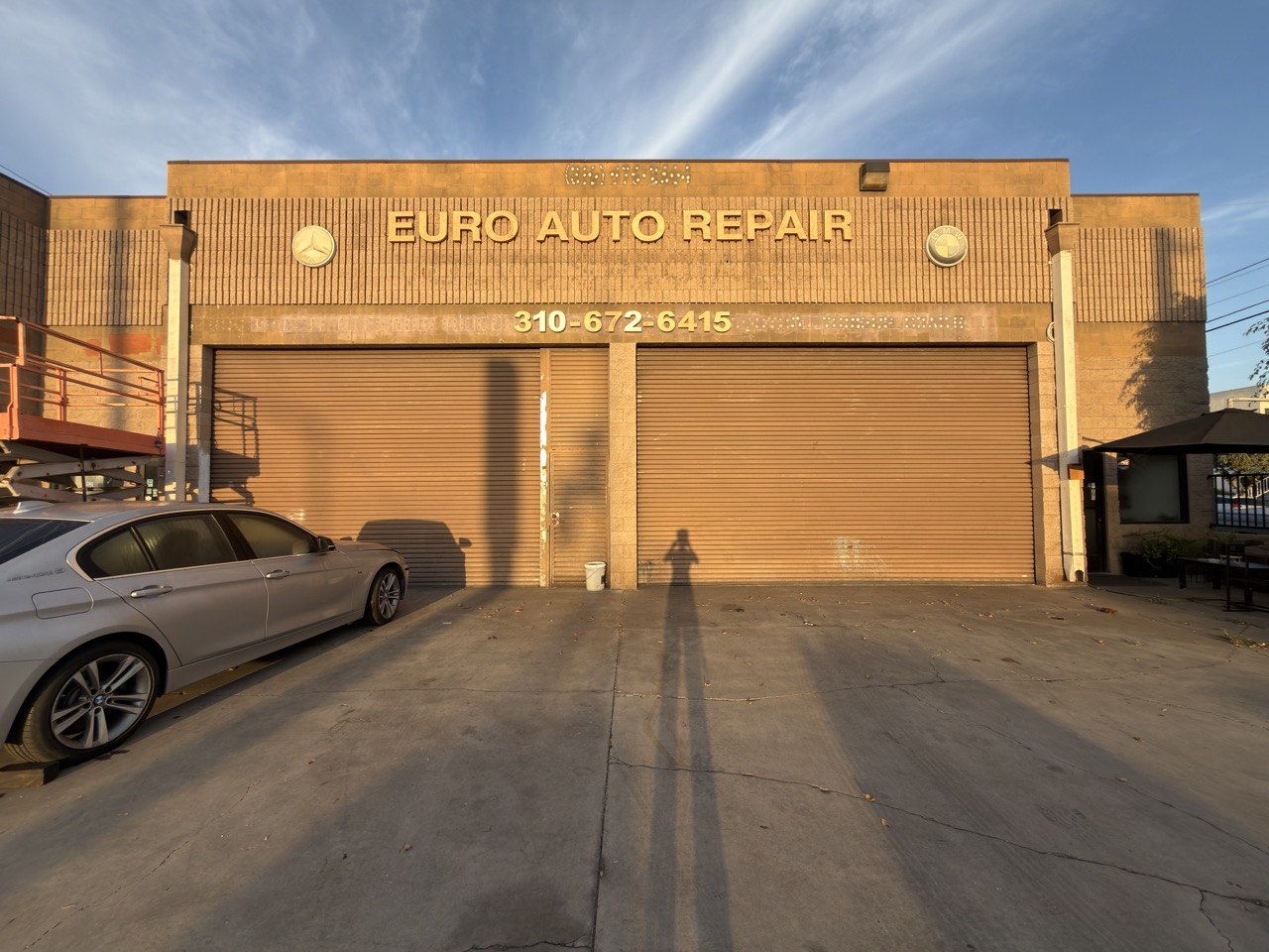 Actual September 26 photo of the shop frontage, with existing tan walls, roller doors and legacy signage